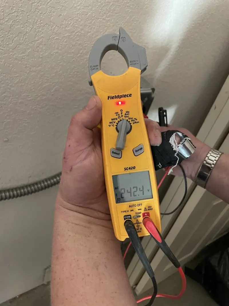 Voltage testing with clamp meter during Whole House Surge Protector in Beachwood